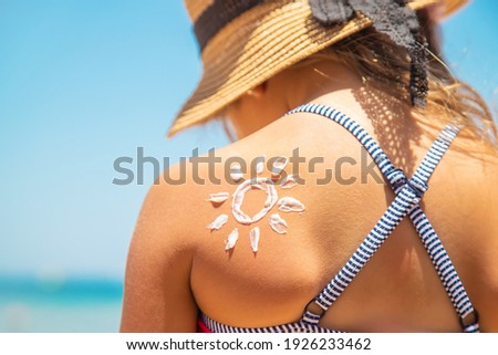 Sunscreen on the skin of a child. Selective focus. nature.