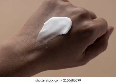 Sunscreen Smear Stroke On Dark Skin Hand, Applying Uv Protection On Woman Skin