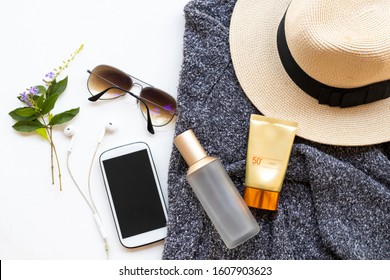 Sunscreen Spf50 ,toners Serum Therapy Cosmetics Health Care For Skin Face With Knitting Wool Sweater ,sunglasses ,mobile And Hat Of Lifestyle Woman In Winter Season Arrangement Flat Lay Style