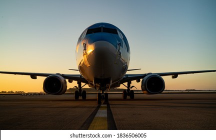 Sunset With 737 Aircraft Sat On The 
 Tarmac Apron Ramp