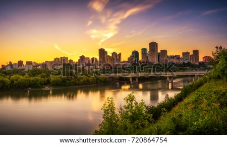 Sunset above Edmonton downtown, James Macdonald Bridge and the Saskatchewan River, Alberta, Canada. Long exposure.