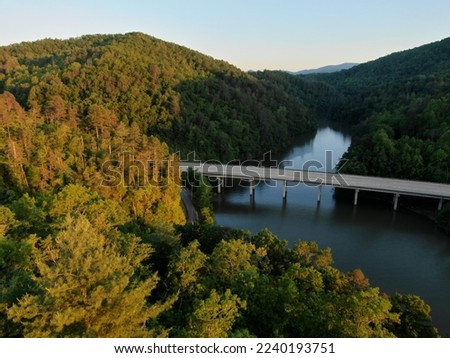 Sunset aerial of highway bridge and forested Fontana Lake in Smoky Mountains in North Carolina