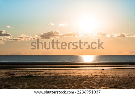 Sunset after ebb in the North Sea in Sank-Peter-Ording, Germany