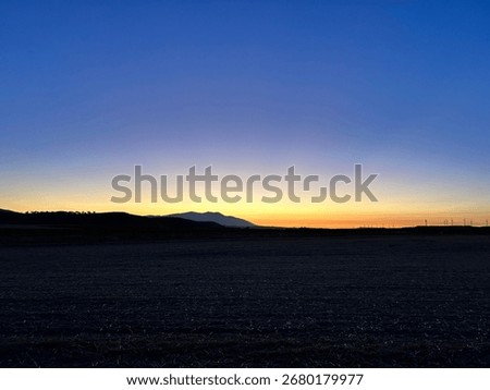 Sunset after sun gone down with dark landscape and dark blue sky