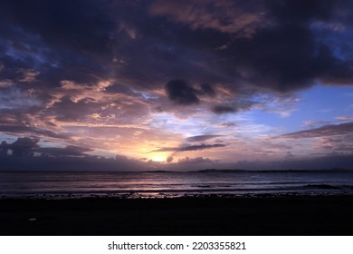 Sunset Against Heavy And Threatening Skies Over Anglesey