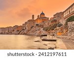 The sunset at Agios Nikolaos - Asteria - Vaporia beach in Syros island, Greece