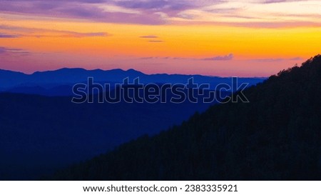 Sunset along Arizona's Mogollon Rim, between Payson and Show Low, in Gila and Navajo Counties, USA, with thousands of trees along the mountains, in summer of 2023.