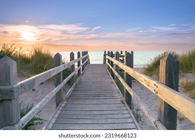 Sunset along the beach with a view over the dunes at a viewpoint with a sunburst - Powered by Shutterstock