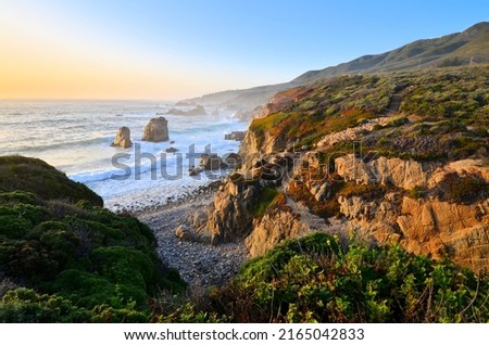 Sunset along the rocky shoreline near Big Sur along the California coast, USA.