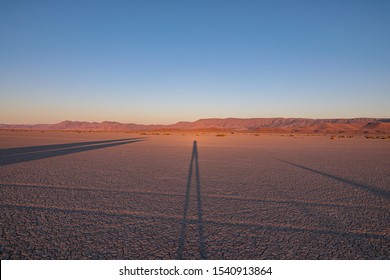 Sunset in Alvord desert. Very long shadows from objects on a land from a low sun