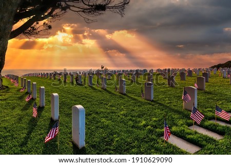 Sunset and American flags on Memorial Day at a national cemetery in southern California.