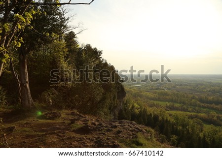 Sunset from the background of the top of a cliff.  Mount Nemo Conservation Area in Ontario Canada, a hotspot for outdoor climbing and hiking.