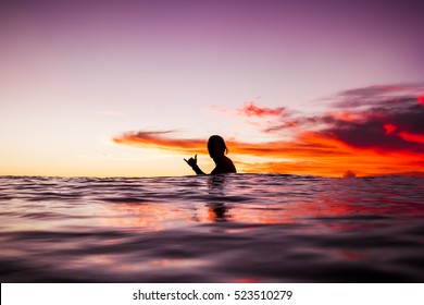 Sunset in Bali and surfer