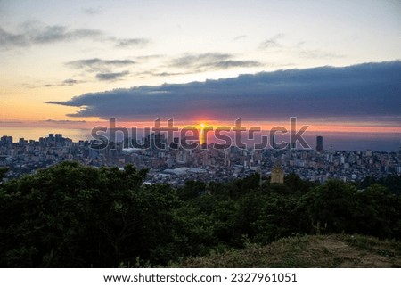 Sunset in Batumi. Dramatic sunset over the Black Sea. Beautiful view of the evening city and sea. Sunset in seaside town.
