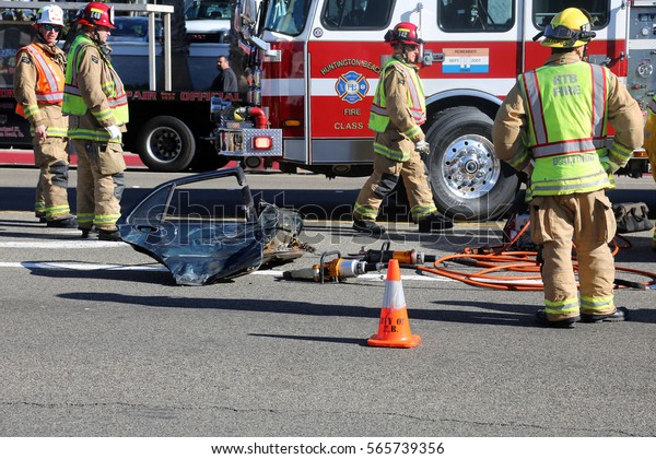 Sunset\
Beach, California - JANUARY 27, 2017: Sunset Beach- Fire Rescue use\
their Extrication tools aka the JAWS of LIFE cut and remove doors\
to remove injured and transport them to Hospital.\
