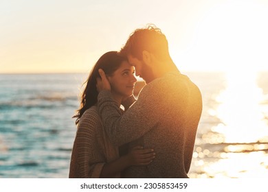 Sunset, beach and couple touching face for relaxing, bonding and quality time on romantic date. Nature, love and man and woman embrace for anniversary or honeymoon on holiday, weekend and vacation - Powered by Shutterstock