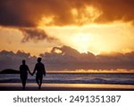 Sunset, beach and couple with travel, holding hands and romance with tropical island, vacation and honeymoon. Seaside, golden hour and man with woman, relationship and holiday for anniversary or love