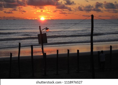 Sunset at the beach with lamps and light post