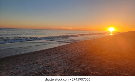 Sunset at beach and ocean waves with pier