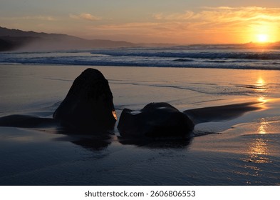 Sunset at the beach with rocks - Powered by Shutterstock - Get 15% off with code: PIKWIZARD15