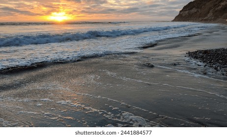 Sunset beach scenes with surfers, tide pools and ancient shorelines at Swamis Reef Surf Park Encinitas California.  - Powered by Shutterstock