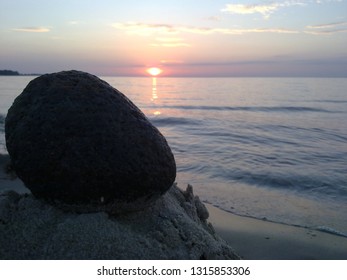 Sunset at the beach with stone