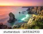 Sunset at Bedruthan Steps. Carnewas and Bedruthan Steps is a stretch of coastline located on the north Cornish coast between Padstow and Newquay, in Cornwall, England, United Kingdom