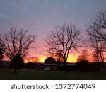 Sunset behind a barn