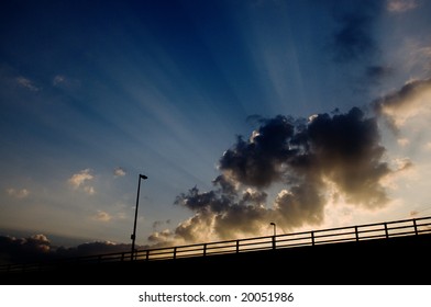 sunset behind bridge