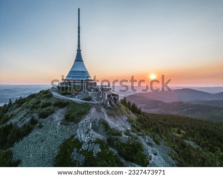 Sunset behind Jested Mountain with unique building on the summit. Liberec, Czech Republic. Aerial view from drone.