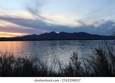 sunset behind the mountains reflection on the water 