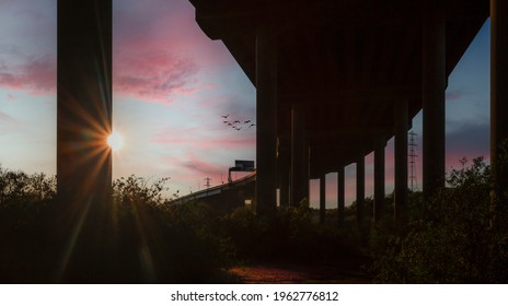 Sunset Behind The Pillars That Support The M4 Motorway In Port Talbot, South Wales UK
