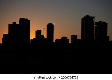 Sunset Behind Silhouette City Skyline - Powered by Shutterstock