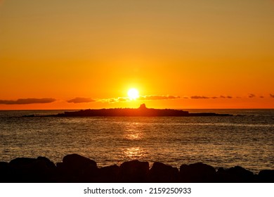 Sunset Behind A Small Rock Island In Front Of Doolin Harbour, County Clare, Ireland