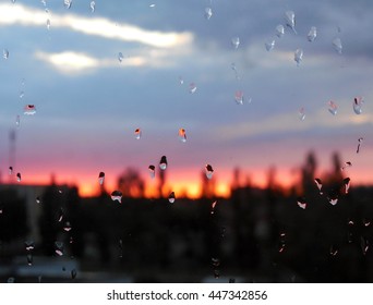 Sunset behind a wet window