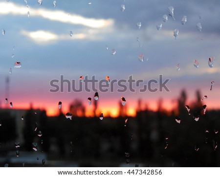 Sunset behind a wet window