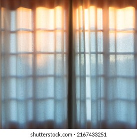 Sunset Behind Window With Curtain.