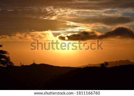 a sunset behing the clouds