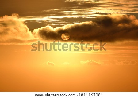 a sunset behing the clouds