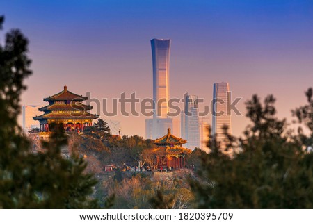 Sunset Beijing cityscape between ancient chinese architecture. historic buildings and  Beijing modern building with sweet sun rise sky, Beijing, China