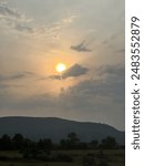 Sunset in between clouds in the sky