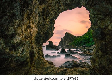 Sunset between rock at the beach