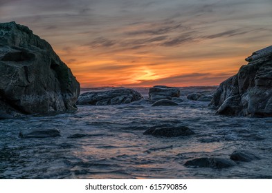 Sunset Between The Rocks At Pacific Ocean