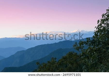 Sunset beyond layers of Himalayan mountain range, Sikkim, India.