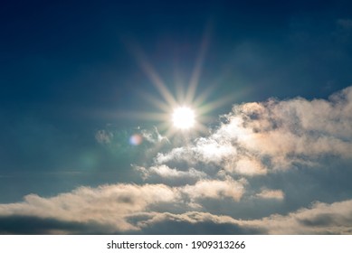 Sunset blue sky, bright sun shines through clouds.Nice sunset evening background. - Shutterstock ID 1909313266