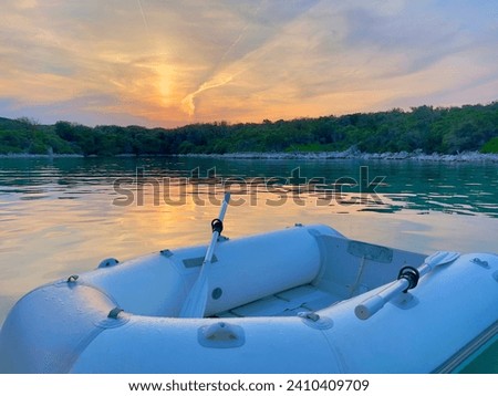 Sunset. Boat. Sunset at the sea. Dinghy. inflatable boat.
