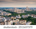 Sunset in Bucharest. Aerial landscape photo with Bucharest city in Romania and its main landmarks such as Palace of Parliament (Casa Poporului in Romanian language) and the National Cathedral.