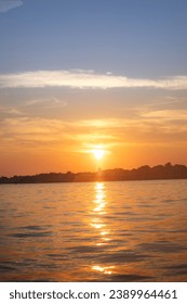sunset by lighthouse by the ocean