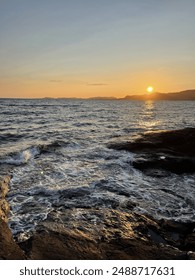 Sunset by the ocean waves