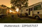 Sunset at campsite with trailer and motorhome on grass
